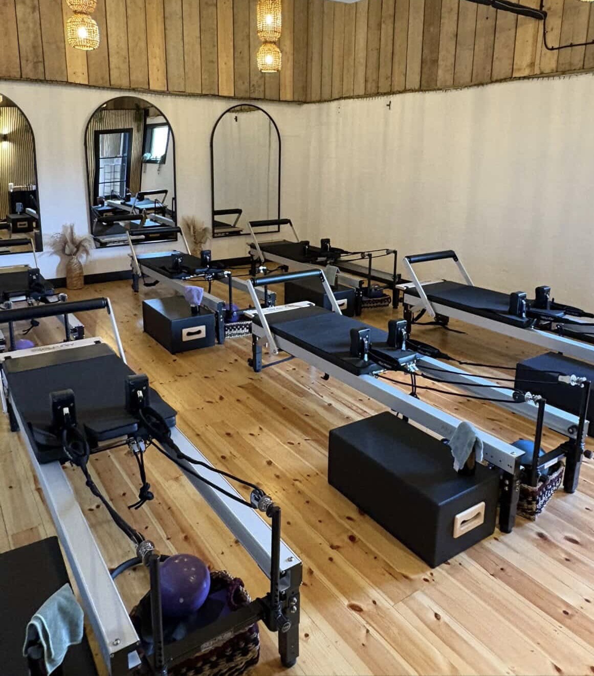 Reformer beds and mirrors inside the AnyBody Clinic studio